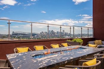 a view of the city from a terrace with a table and chairs